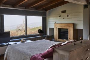 a bedroom with a large bed and a fireplace at Agriturismo Prato del Re in Prignano sulla Secchia