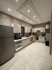 a large kitchen with white cabinets and appliances at Appartements Guéliz Zerktouni in Marrakech