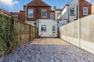 a driveway leading to a house with a fence at Mia's House: Park view +Parking in Nottingham