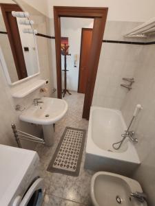 a bathroom with a sink and a toilet and a tub at Casa Martesa in Loano