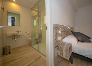 um quarto com um chuveiro e uma cama e uma casa de banho em Agi Gloria Rooms em Roses