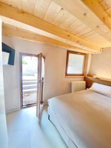 Un dormitorio con una cama grande y una ventana. en Boutique Alpine Studio by SupaStays, en Courmayeur