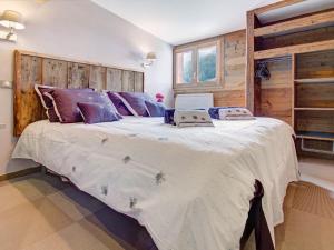 a large bed in a bedroom with wooden walls at Appartement Morzine, 3 pièces, 6 personnes - FR-1-627-34 in Morzine