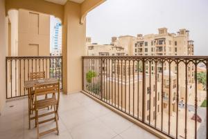a balcony with a table and a view of buildings at Retreat near Burj Al Arab in Dubai