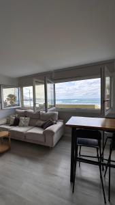 a living room with a couch and a table at Blue Sea in Moya