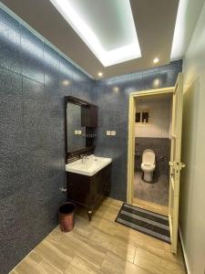 a bathroom with a sink and a toilet at شقة خمس غرف مطلة على طريق السودة in Abha +49 photos