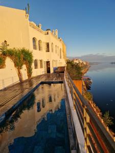 a house with a swimming pool next to a body of water at L'Oum Errebia in Azemmour