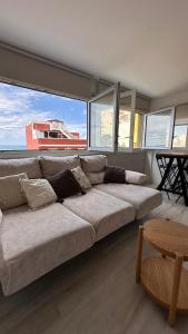 a large couch in a room with a large window at Blue Sea in Moya