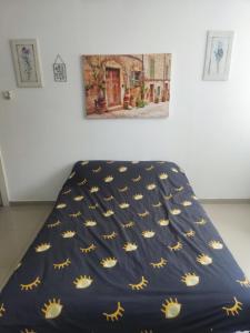 a bed with a blue comforter with yellow stars at נוף ים אילת in Eilat