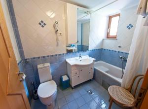 a bathroom with a sink and a toilet and a tub at MalAna in Zaton +68 photos