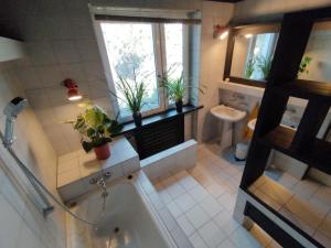 a bathroom with a tub and a toilet and a sink at Nest 4 Rest in Konstancin-Jeziorna