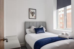 a bedroom with a bed with two stuffed animals on it at Edgware road apartments in London