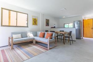 a living room with a couch and a table at Beachfront Duplex #A10 em Barro Preto by Carpediem in Prainha