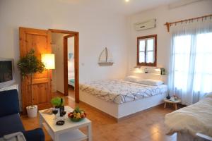 a bedroom with a bed and a living room at Anofli Suites in Skopelos Town +62 photos