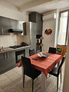 a kitchen with a table with a red table cloth at Bono plages récemment rénové février 2024 in Mèze