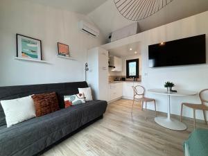 Studio Vue Mer - Piscine - Porticcio في بورتيكيو: غرفة معيشة مع أريكة وطاولة