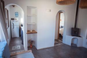 a hallway with a kitchen and a refrigerator in a room at La Pascana in Cachí