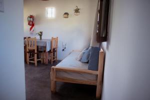 a bedroom with a bed and a dining room with a table at La Pascana in Cachí