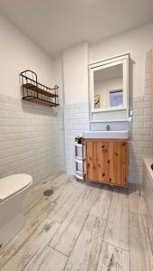 a bathroom with a sink and a toilet and a mirror at Blue Sea in Moya +39 photos