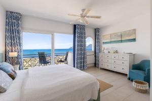 a bedroom with a bed and a view of the ocean at Beach house in 1st sea line of Son Serra in Son Serra de Marina