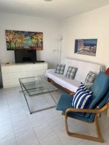 a living room with a bed and a glass table at Casa Torres in San Bartolomé de Tirajana