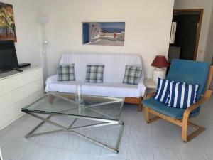 a living room with a couch and a glass table at Casa Torres in San Bartolomé de Tirajana