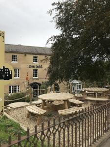 a group of picnic tables in front of a building at The Sun Hotel in Warkworth