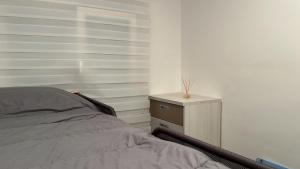 a bedroom with a bed and a night stand at Apartament L'Alba 2 in Tossa de Mar