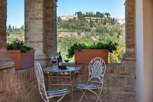 a table and chairs on a patio with a view at Agriturismo Nobile in Montepulciano