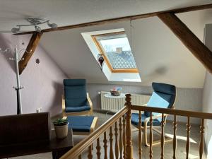 a room with blue chairs and a staircase at Auszeit Sembzin in Klink