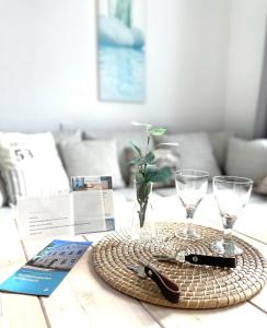 un tavolo con un vassoio con bicchieri e un libro di Gästehaus Teerlings Hafen a Borkum