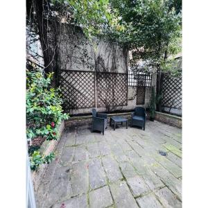 a patio with two chairs and a table at G3- Great Studio for 2 with Patio near Hyde Park in London
