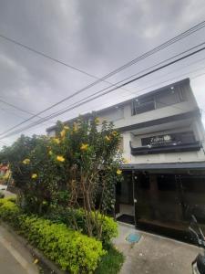 a building with trees and flowers in front of it at Hotel Zafiro Boutique in Bogotá +35 photos