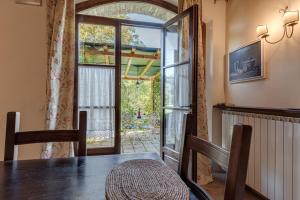 a dining room with a table and a sliding glass door at Agriturismo Nobile in Montepulciano