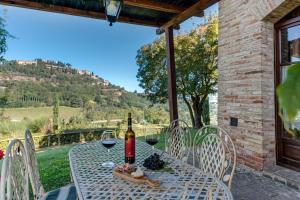 a table with a bottle of wine on it on a patio at Agriturismo Nobile in Montepulciano