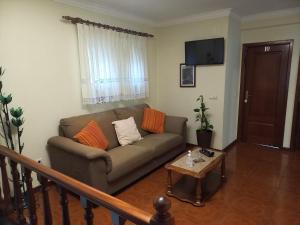 a living room with a couch and a table at Residencial Ribeiro in Geres