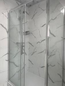 a shower with a glass door in a bathroom at Stunning 3-Bed House in Manchester in Manchester