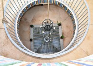 an overhead view of a spiral staircase with a door at L'Oum Errebia in Azemmour