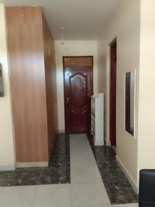 - un couloir avec une porte en bois dans l'établissement Studio Apartment Nyali, à Mombasa