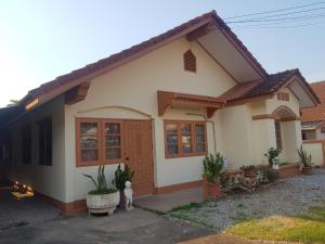 a small house with at Bualuang Country Village - Pet Friendly in Uttaradit