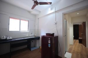 a bathroom with a sink and a ceiling fan at The Byke Studio Pure Veg Apartment, Thane in Thane