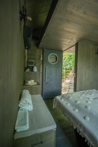 a small room with a bed and a kitchen at Hrad Kunzov Glamping & SPA & Restaurant in Přerov