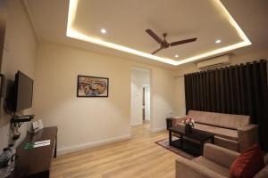 a living room with a couch and a ceiling fan at The Byke Studio Pure Veg Apartment, Thane in Thane