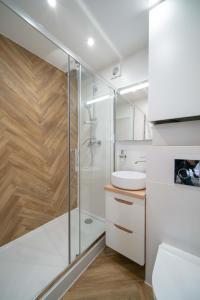 a bathroom with a shower and a toilet and a sink at Monako in Kłodzko