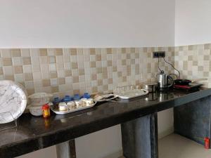 a counter in a kitchen with a counter top with food at Zanita Heights Seaview Apt in Bogmalo