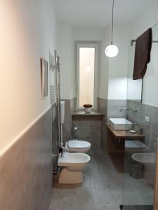 a bathroom with a toilet and a sink at Fenix Rooms in Trieste
