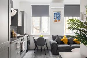 a living room with a couch and a table at Edgware road apartments in London