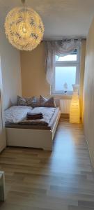 Кровать или кровати в номере Ferienwohnung ASL