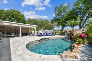 a swimming pool in a yard with a patio at The Palm by DNY Prime in St. Petersburg