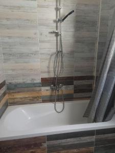 a shower in a bathroom with a bath tub at Al makramia compound in Hurghada